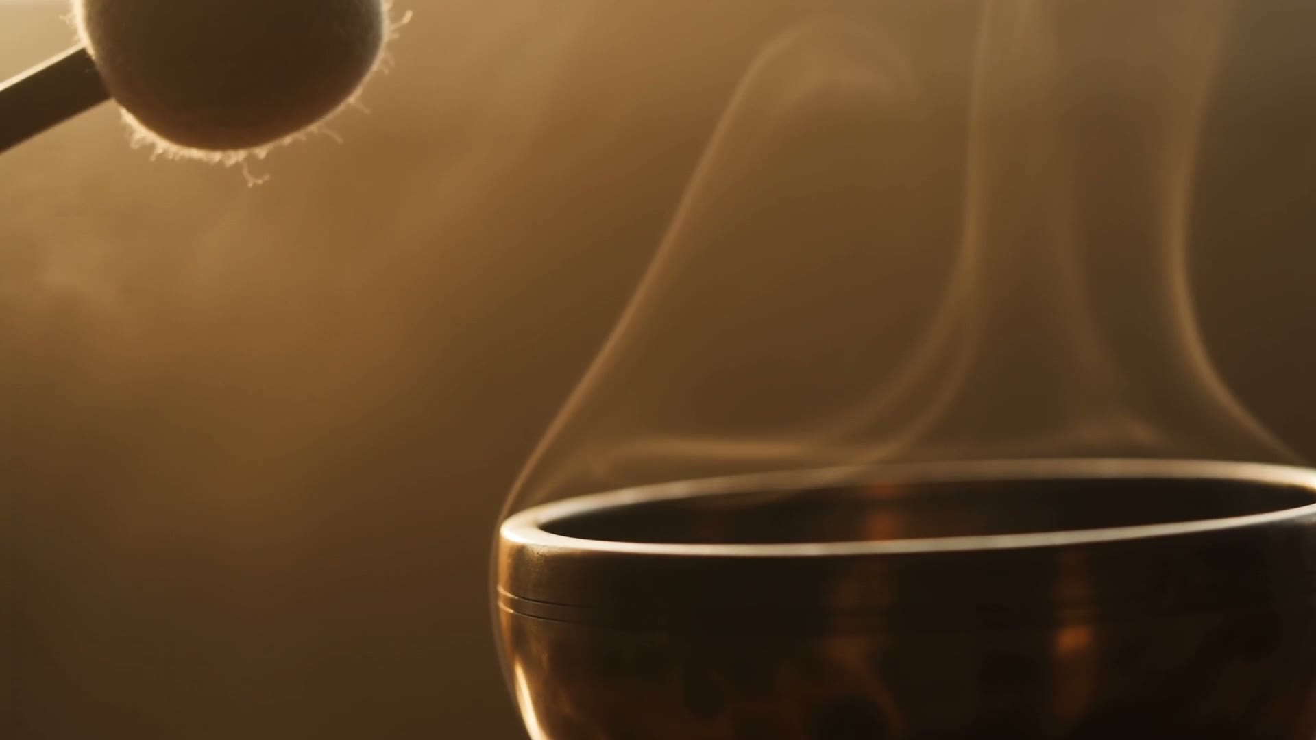An aged bronze singing bowl in warm dawn light